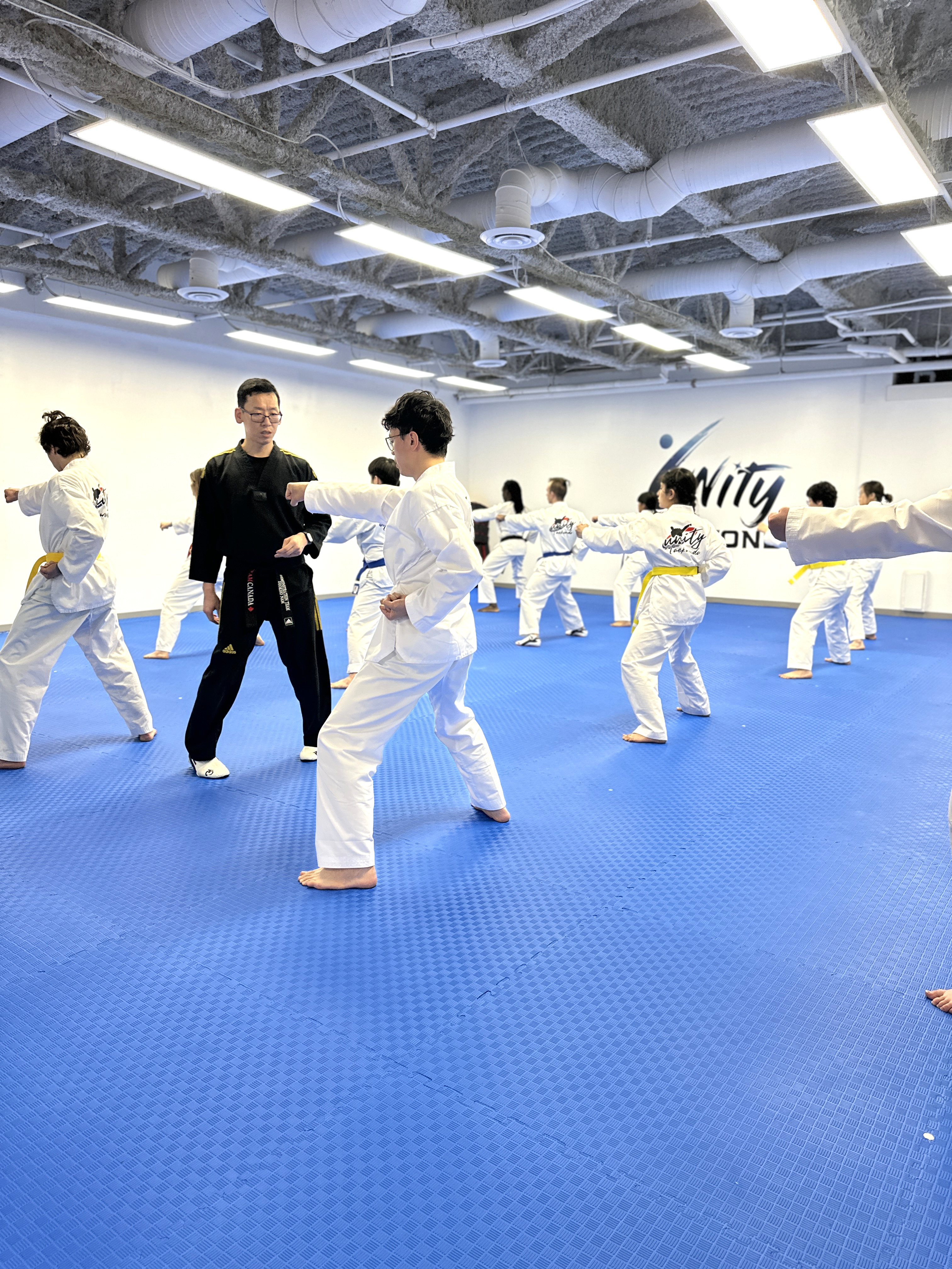 Master Nam coaching a teen student during a Taekwondo class in Chilliwack