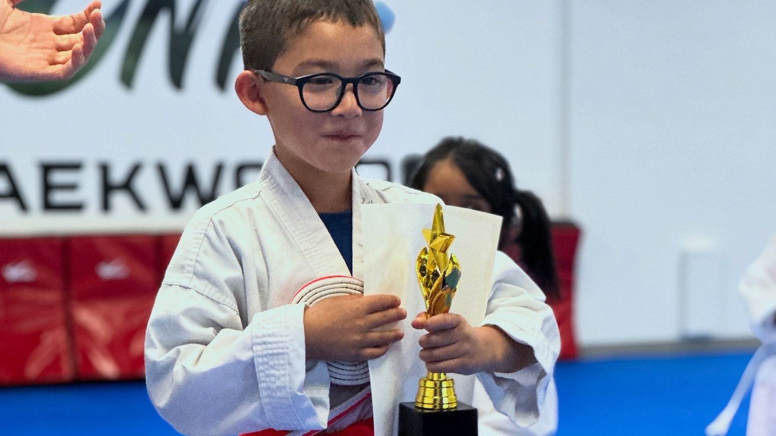 A Unity Taekwondo student in Chilliwack holding his first trophy
