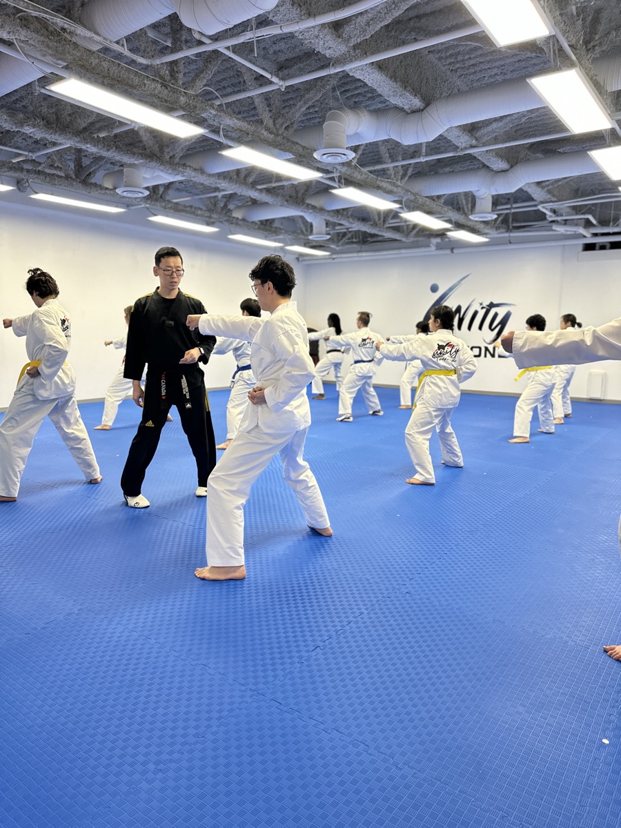 Teen and adult students practising self-defence at Unity Taekwondo