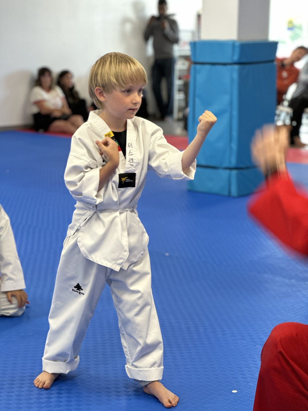 A young Unity Taekwondo student standing tall and confident in a taekwondo uniform in Chilliwack, BC