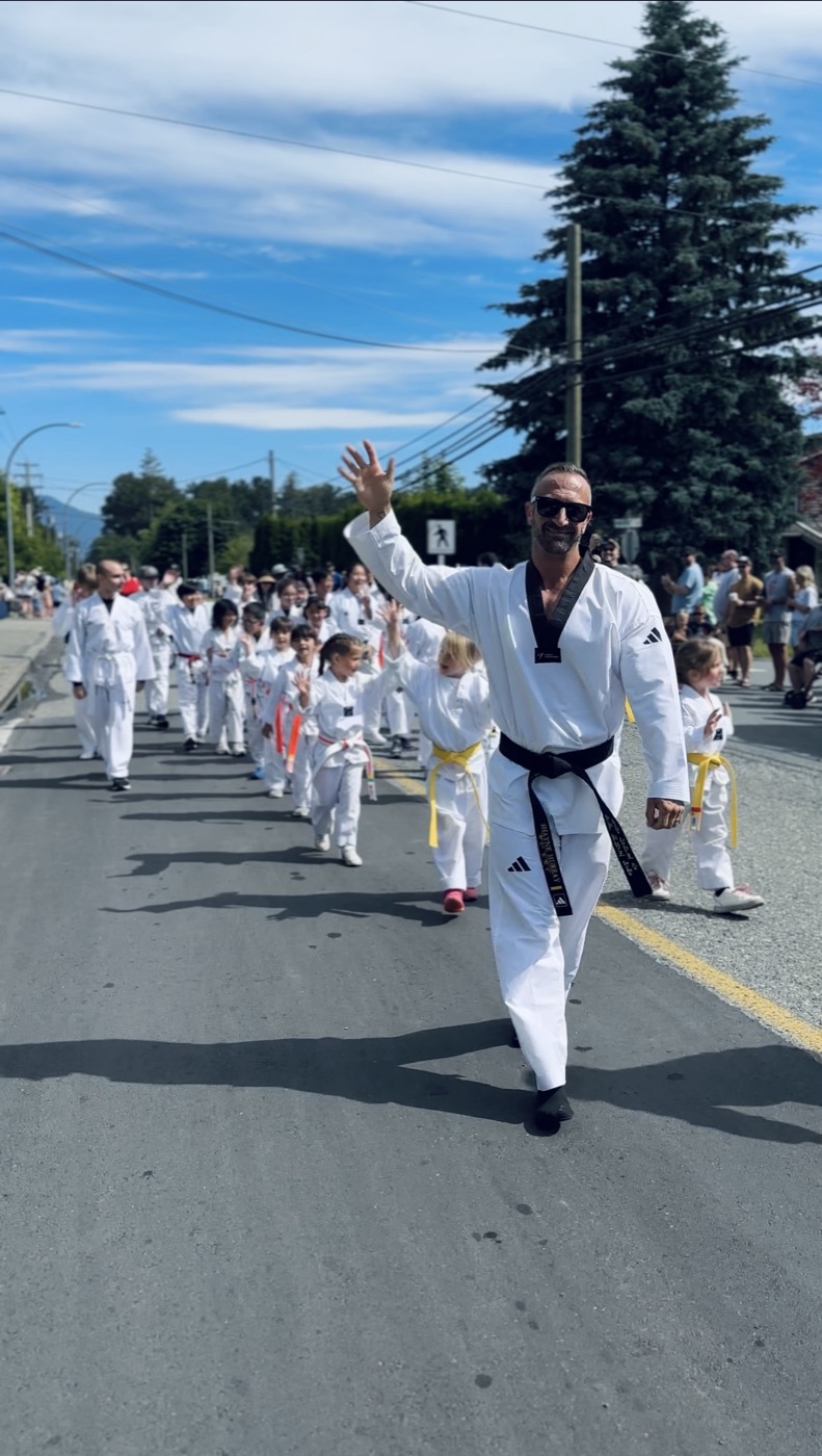 Master Nam leading Unity Taekwondo students through the Yarrow Day parade in Chilliwack